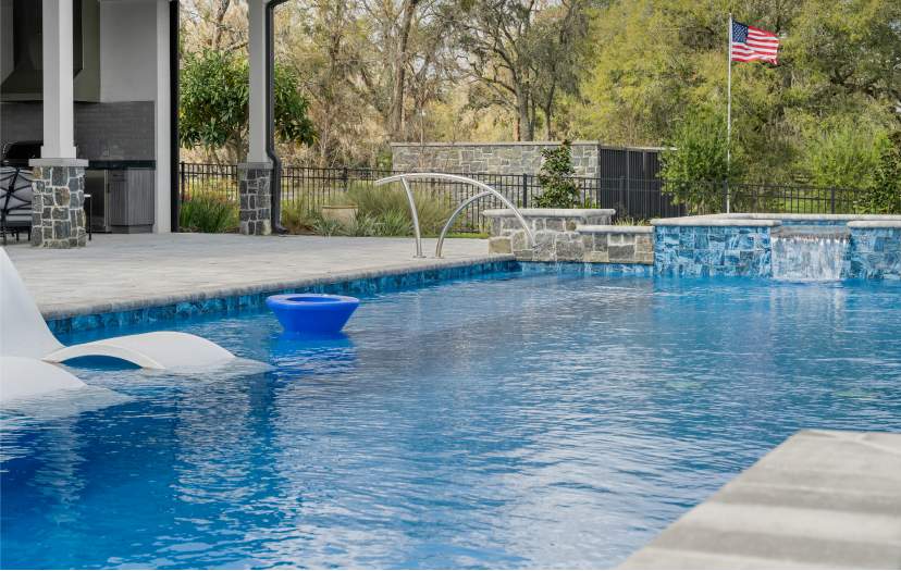 A pool with a ledge for lounge chairs