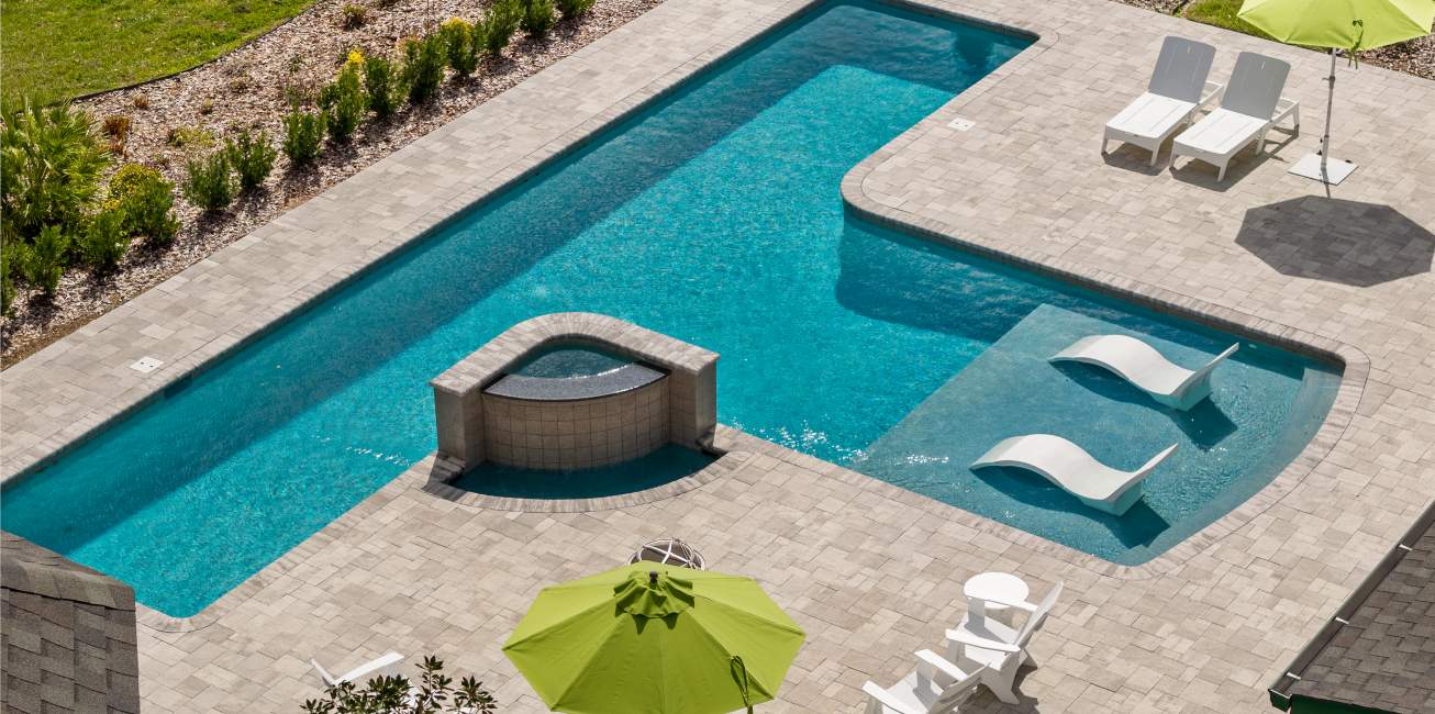A pool with a ledge for lounge chairs