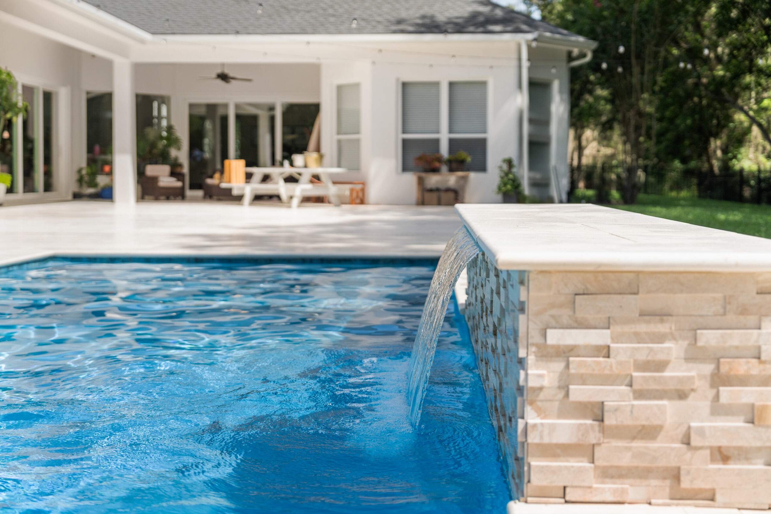 Pool area featuring a small waterfall