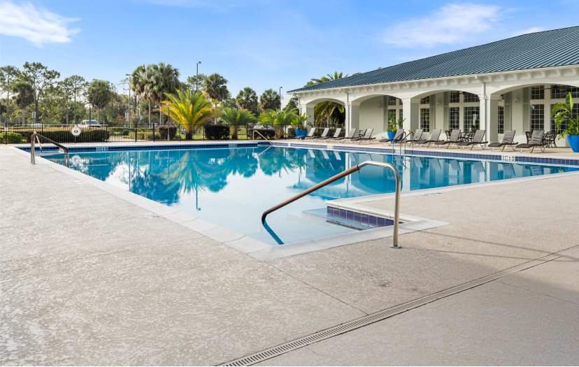Large pool surrounded by lounge chairs