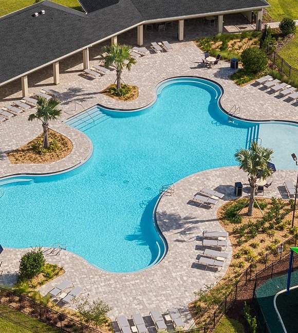Aerial view of a large swimming pool surrounded by lounge chairs