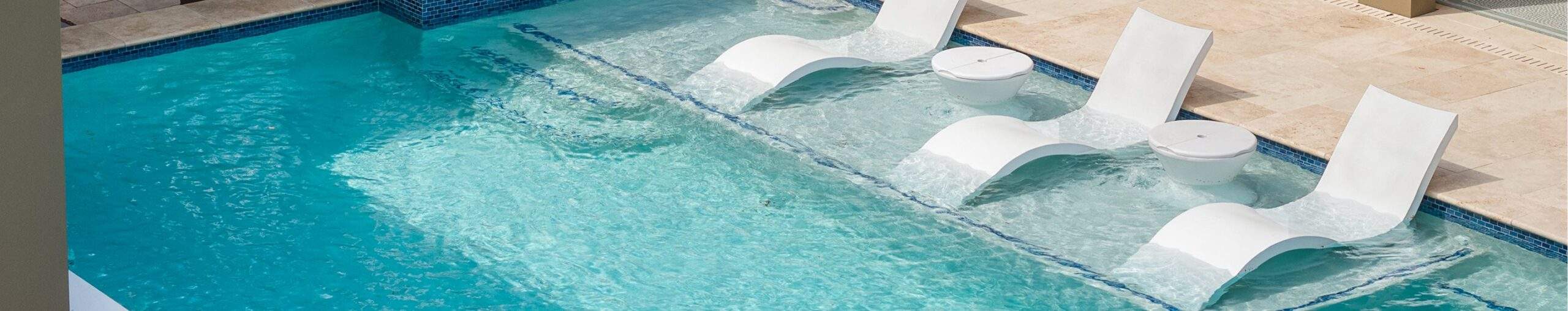 A pool with a ledge for lounge chairs