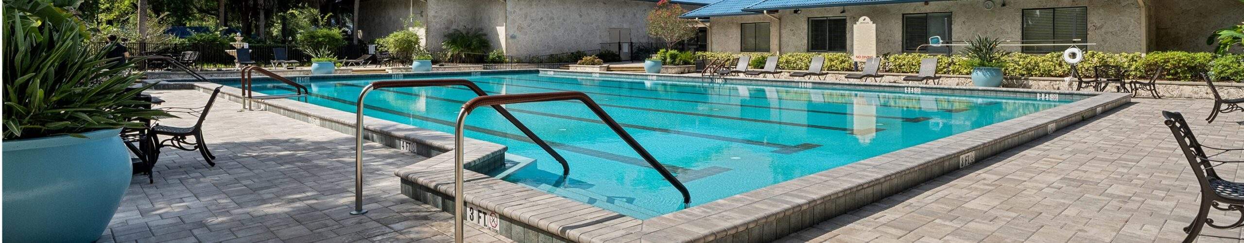 Patio with lap pool surrounded by lounge chairs