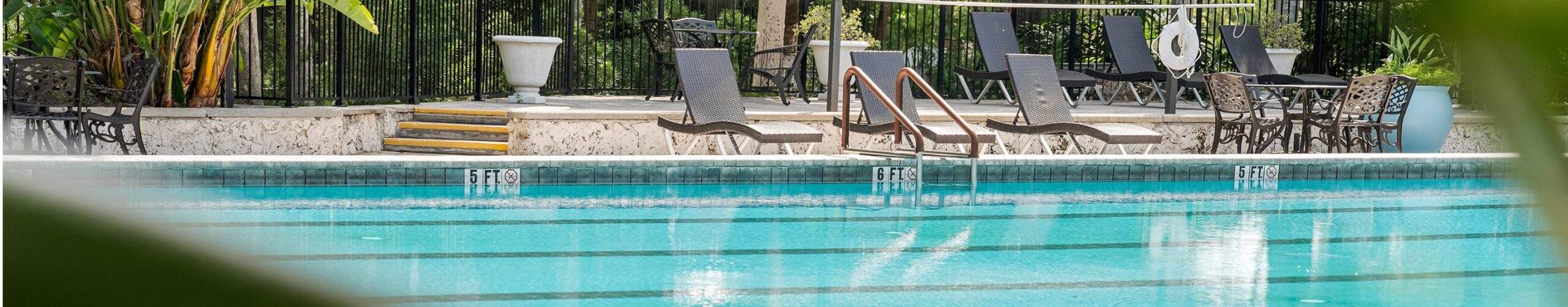 Lap pool surrounded by patio chairs
