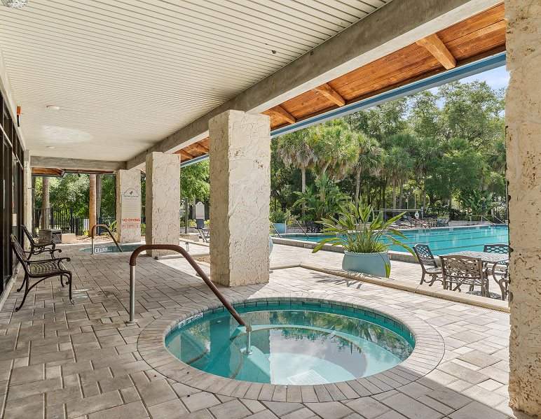Patio with hot tubs and a pool