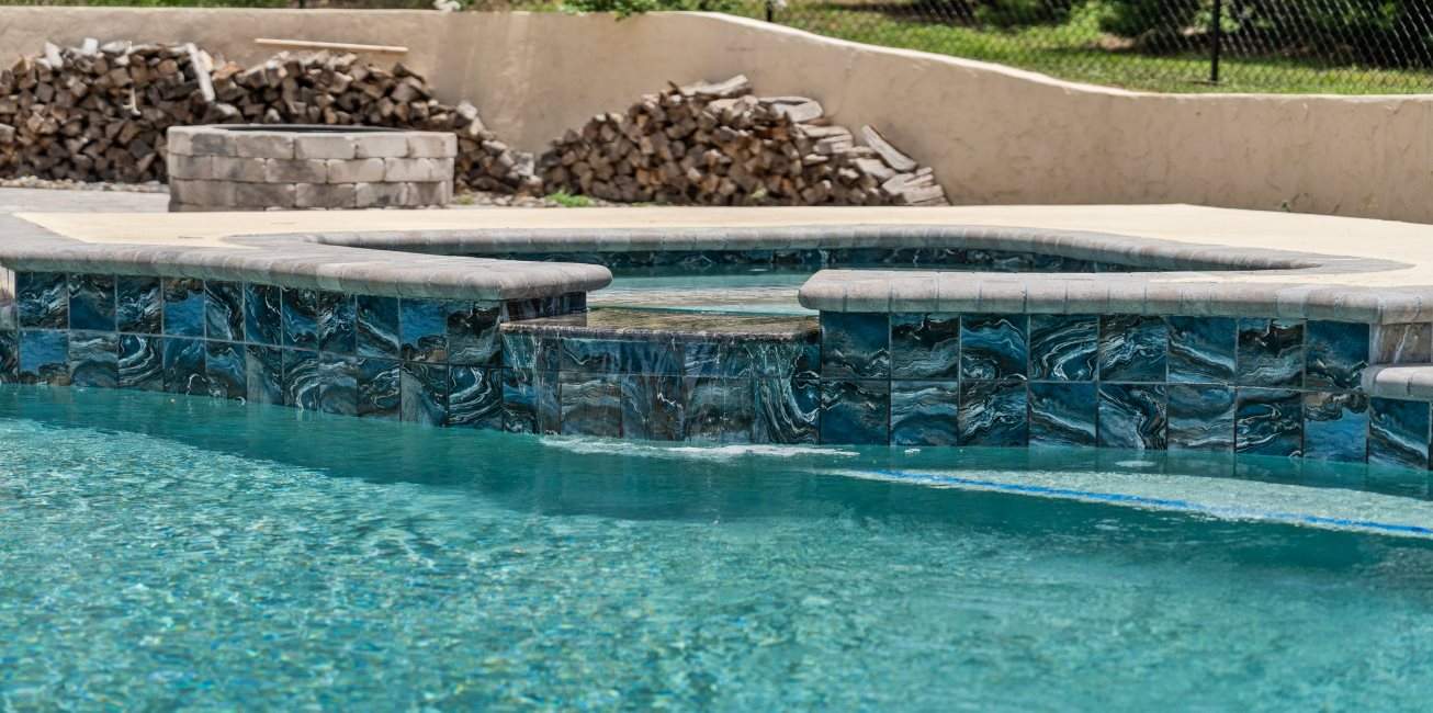 Hot tub waterfall feature into the pool