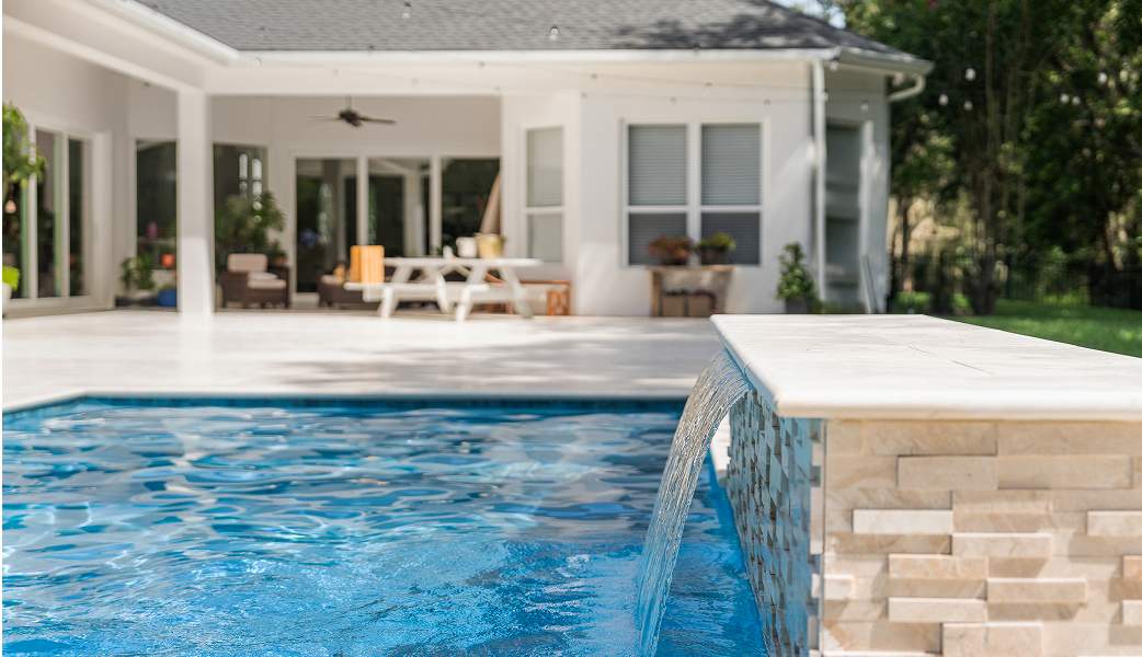Pool area featuring a small waterfall