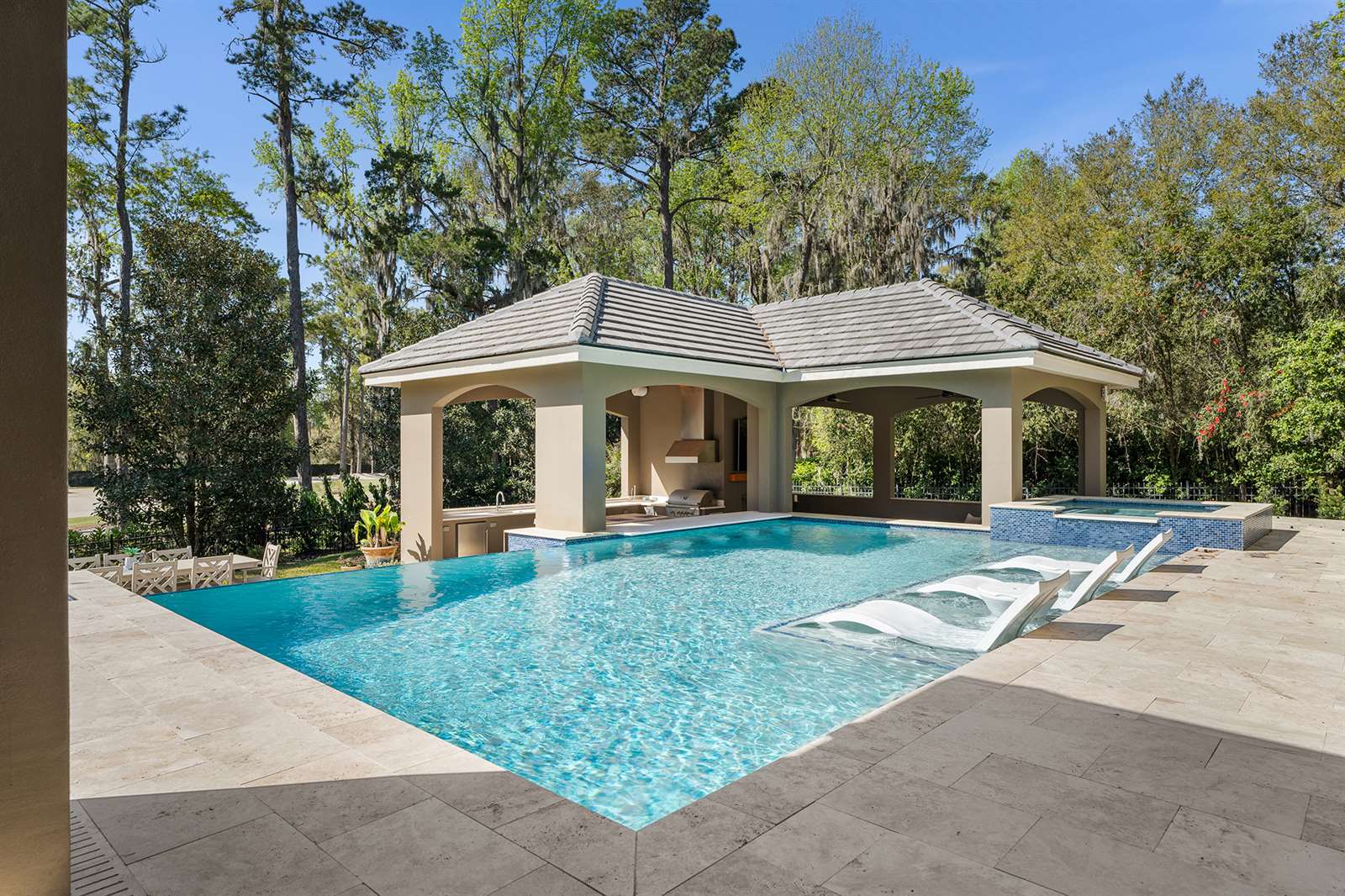 pool area featuring a gazebo and several lounge chairs